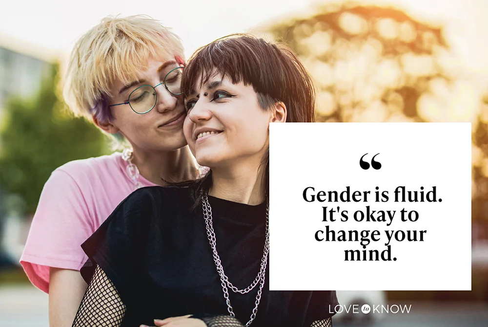 Young gender fluid couple hugging on city street