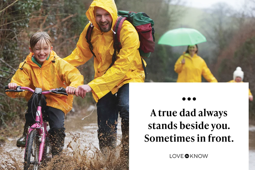 Family out in rain and puddles with bike
