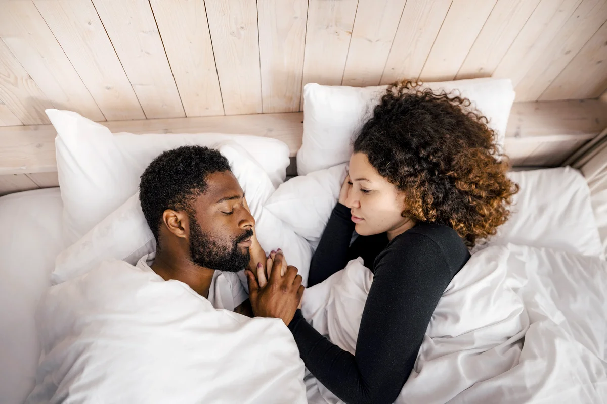 Couple sleeping on bed