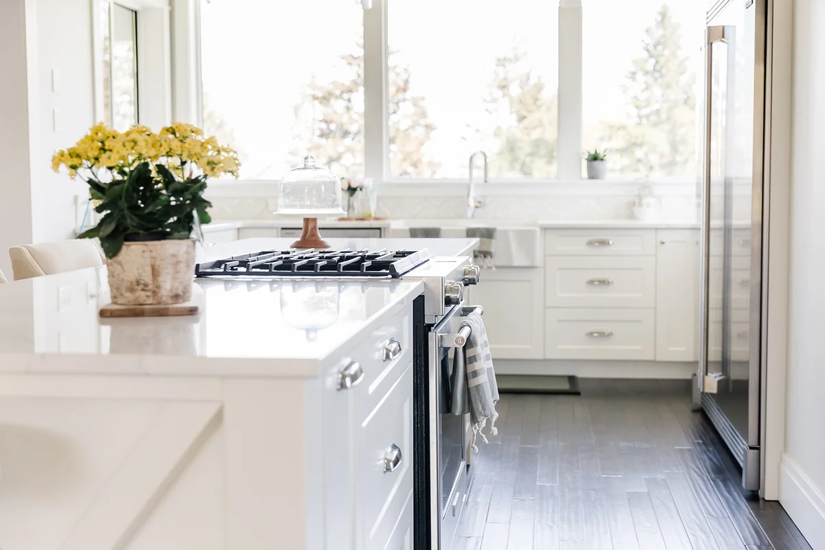 Bright white kitchen island with yellow flowers