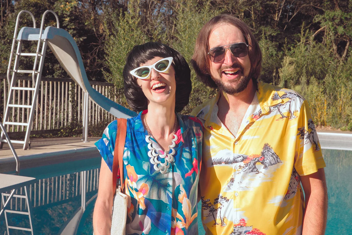 Retro 1970s Couple Laughing at Pool Party