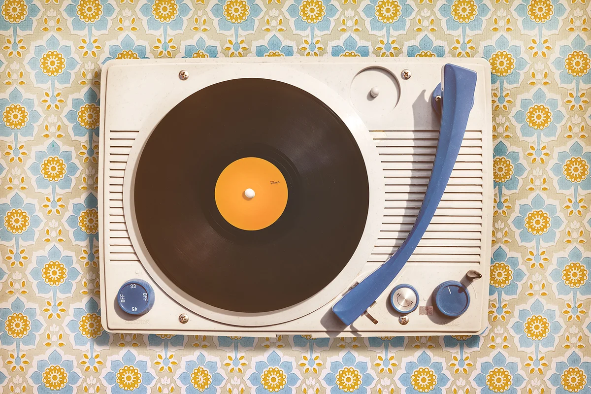 Vintage record player on top of flower wallpaper