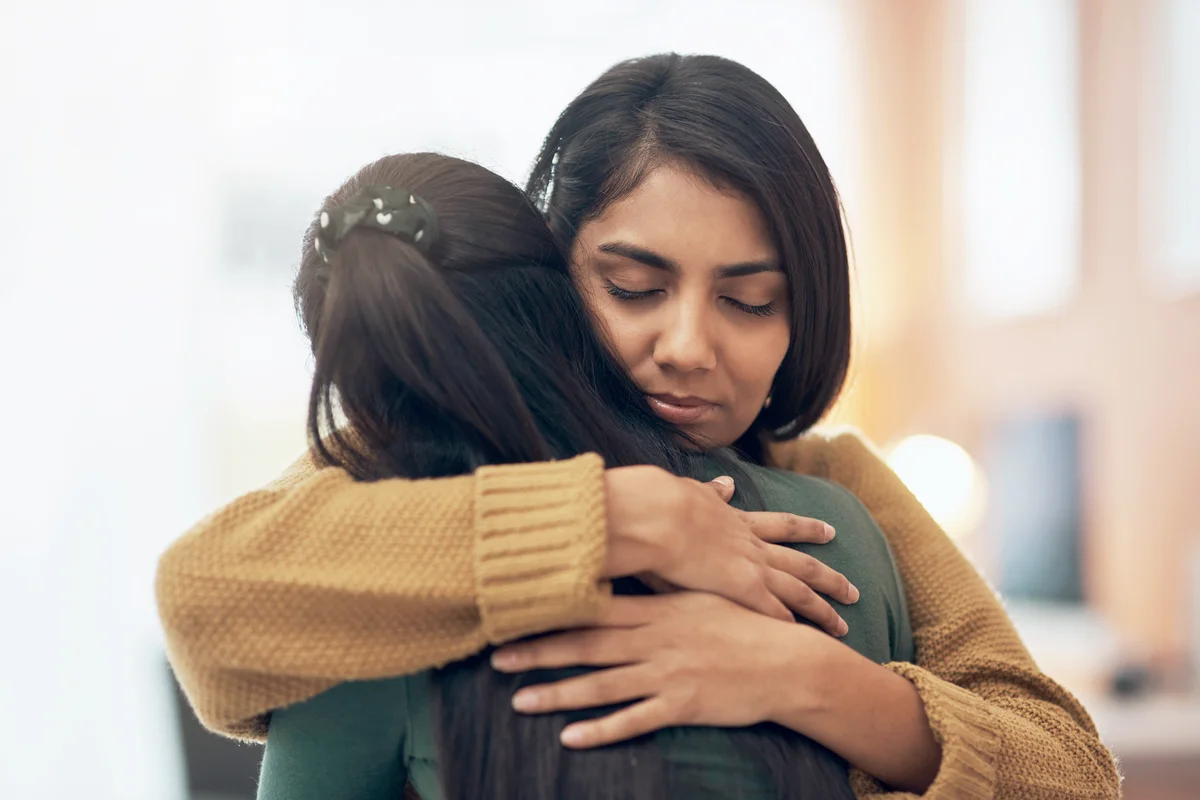 Two young women embracing each other