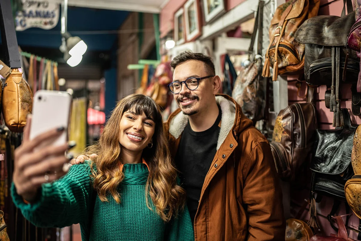 Happy couple taking a selfie in a store