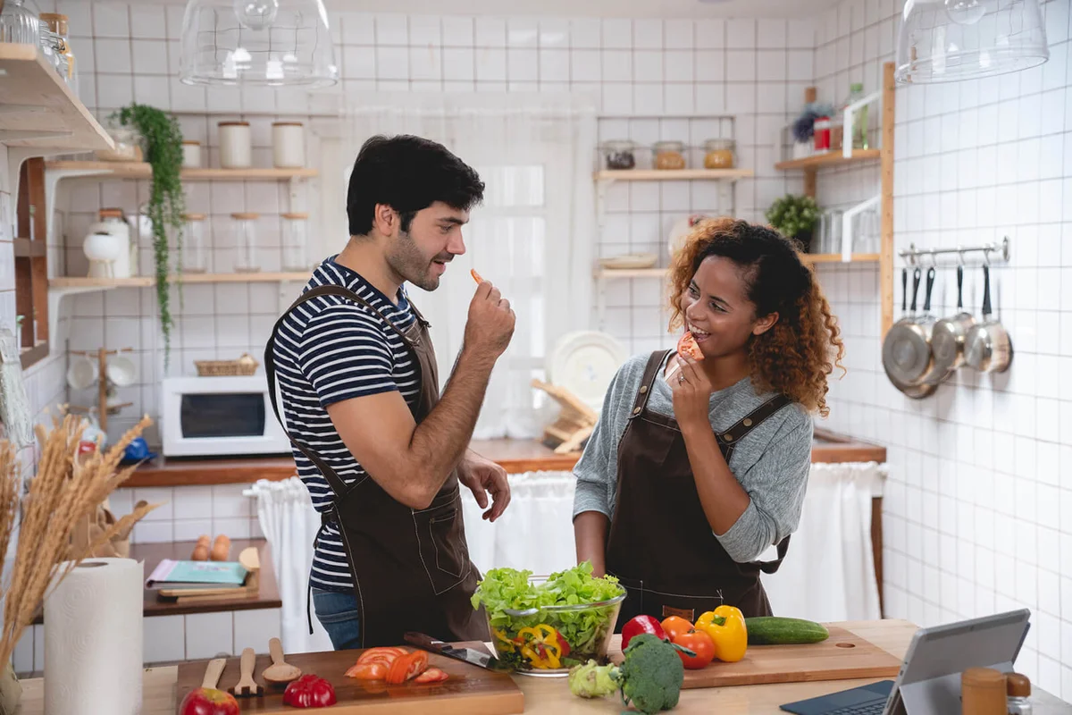 Affectionate couple preparing salad