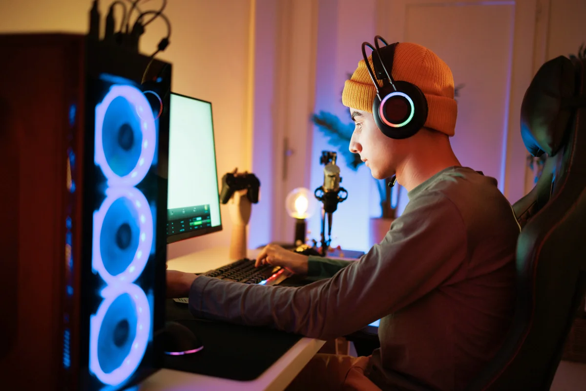 Teenager playing video game in his room