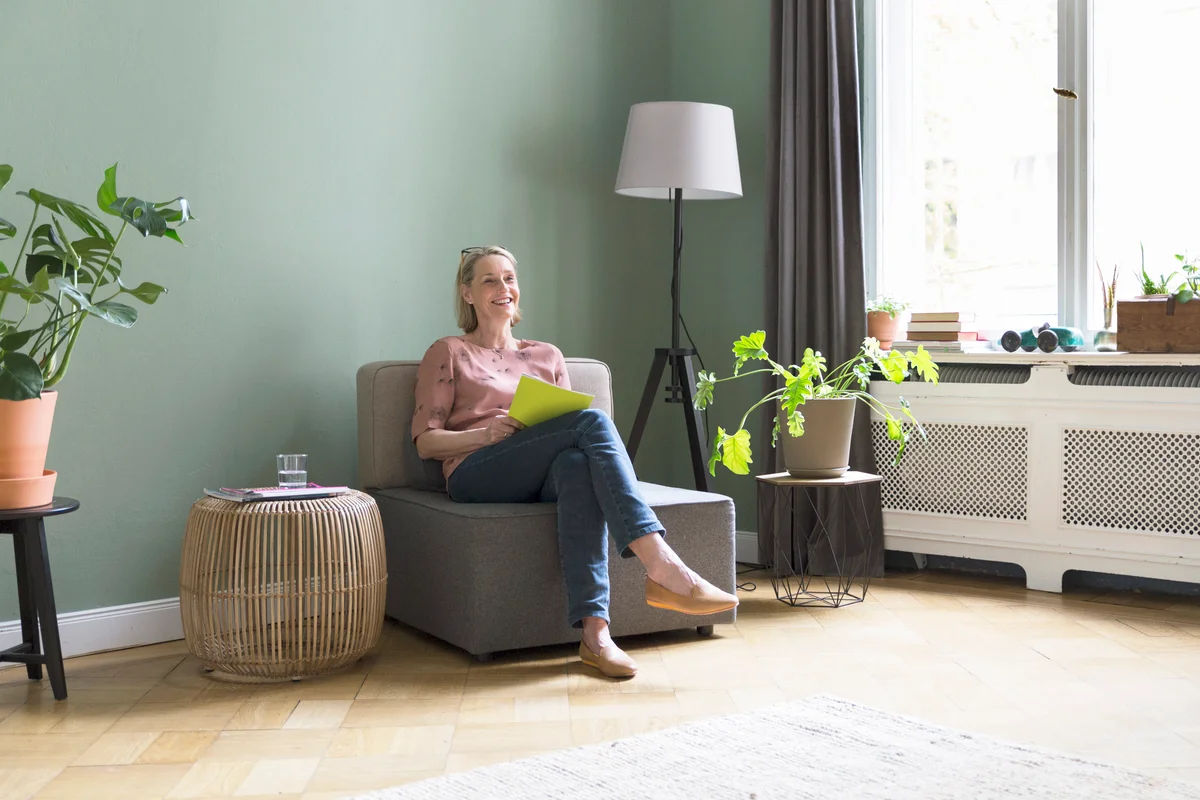 woman reading beside a drum end table