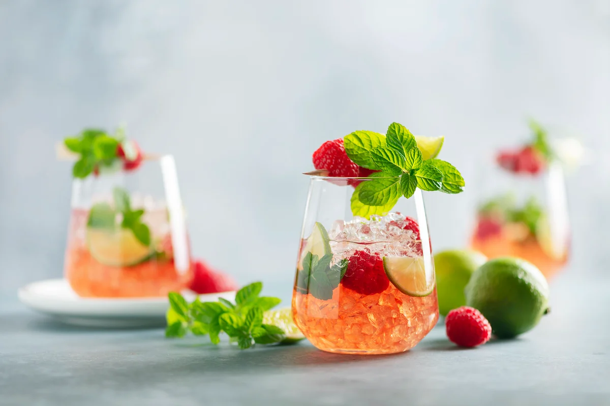 Virgin raspberry mojitos on table