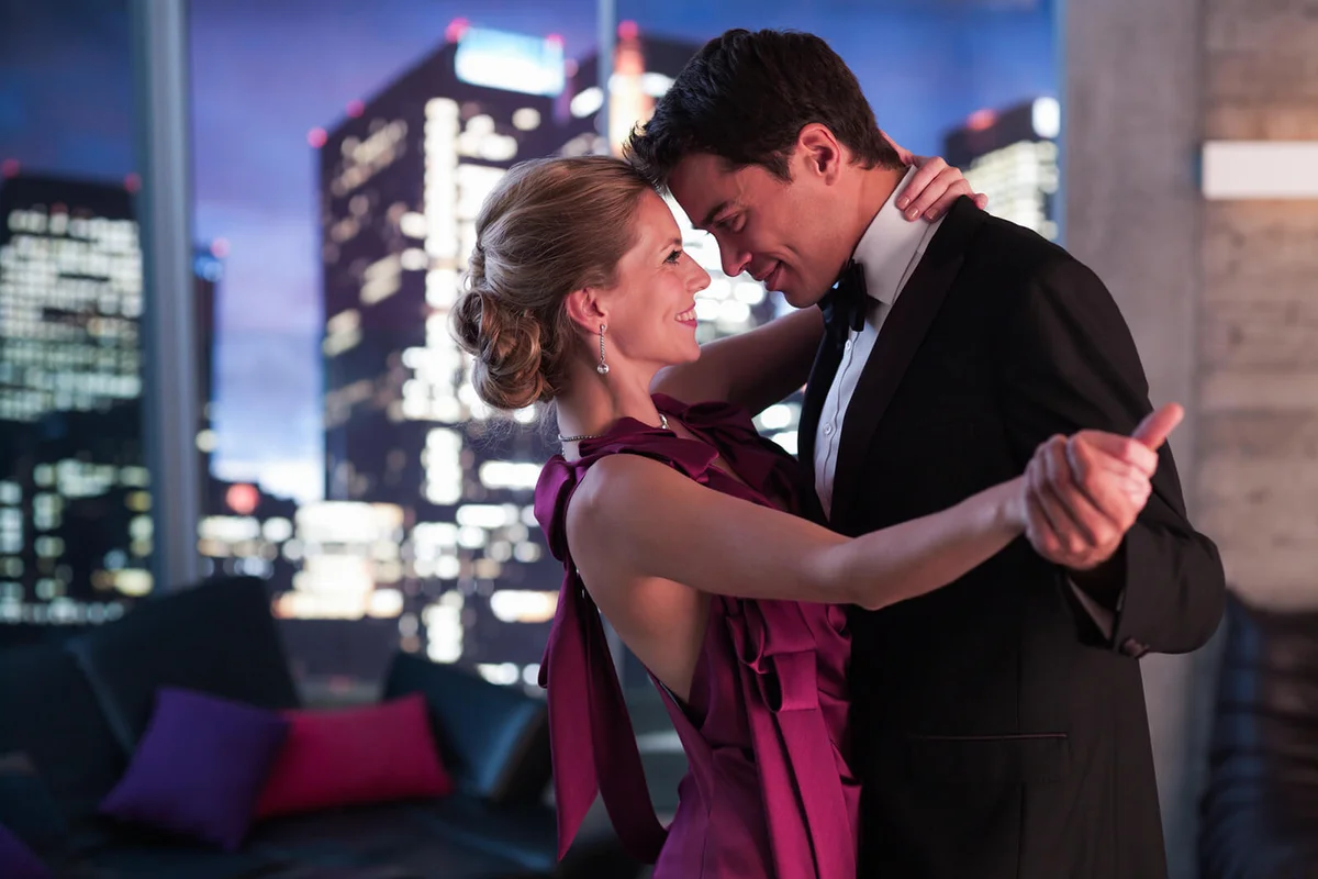 Elegant couple dancing in living room