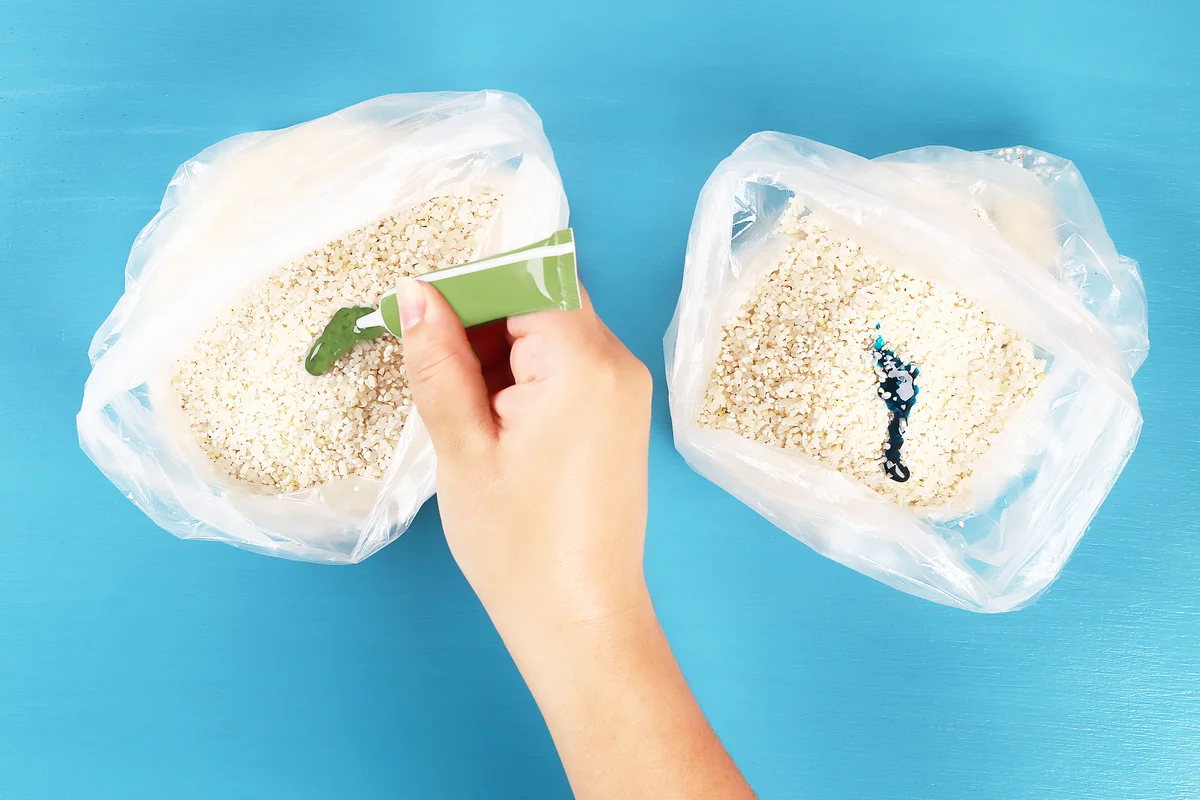 Kid putting food coloring on rice