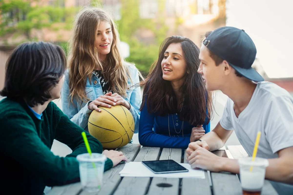 Junior students hanging out on a table