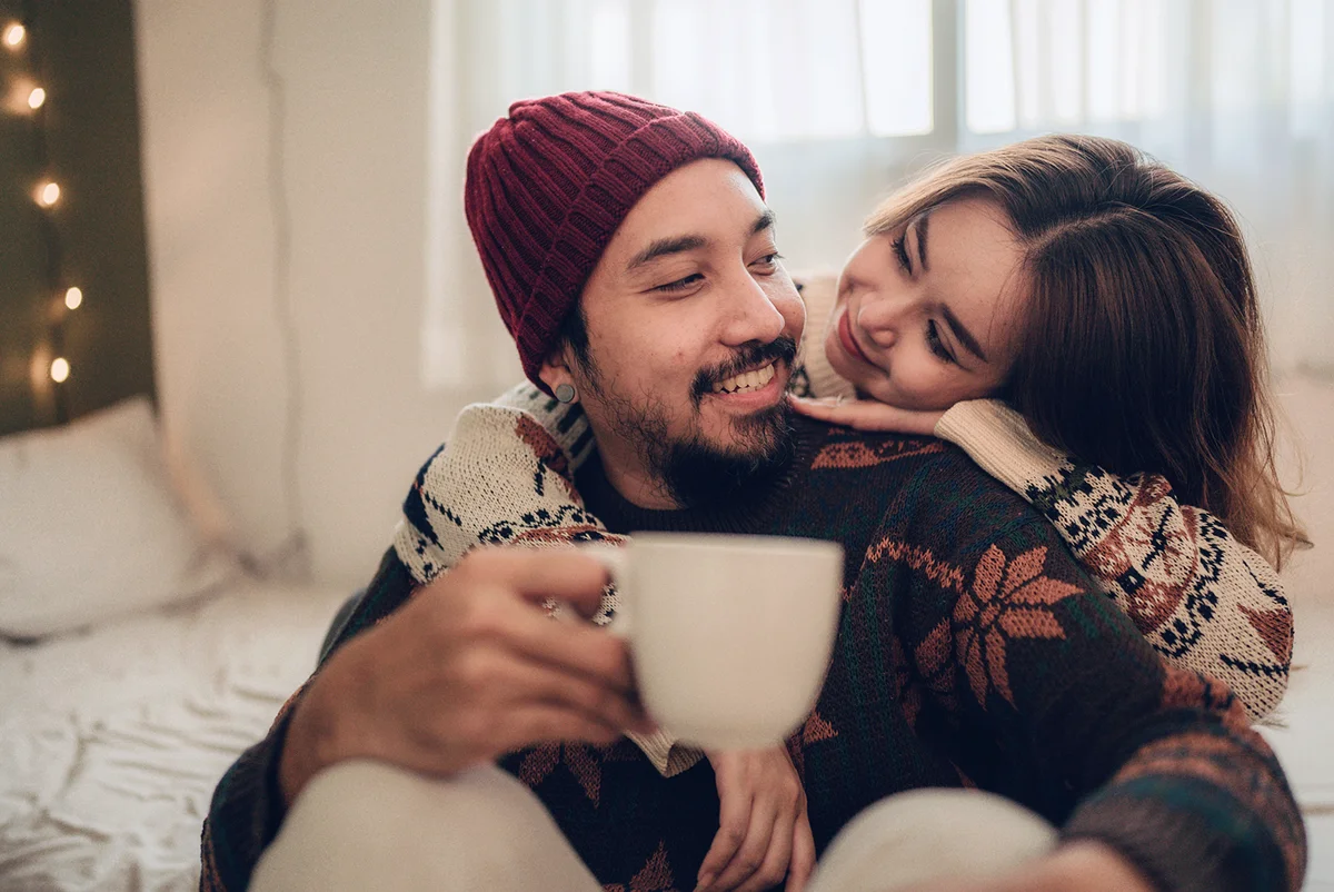 Happy young couple relaxing talking laughing