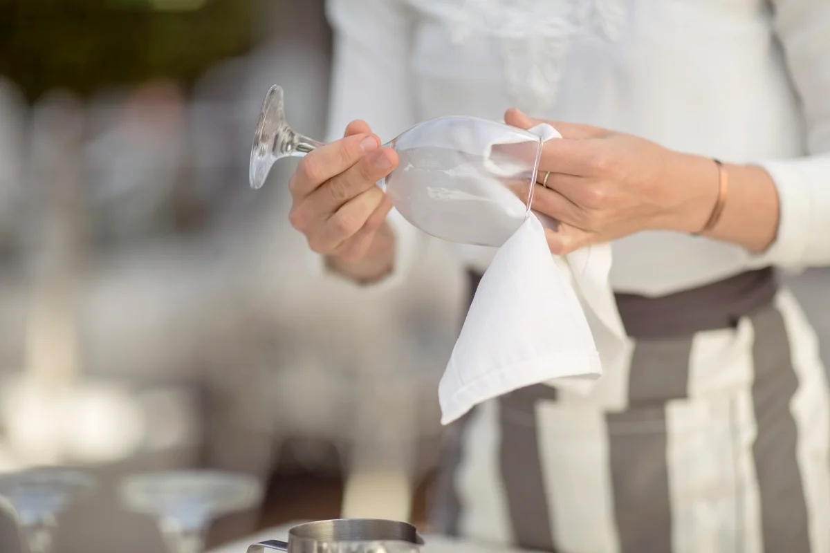 Woman cleaning wine glass