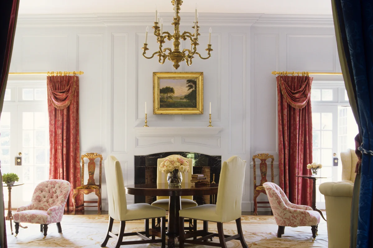 Chandelier over Round Pedestal Table in Traditional Living Room