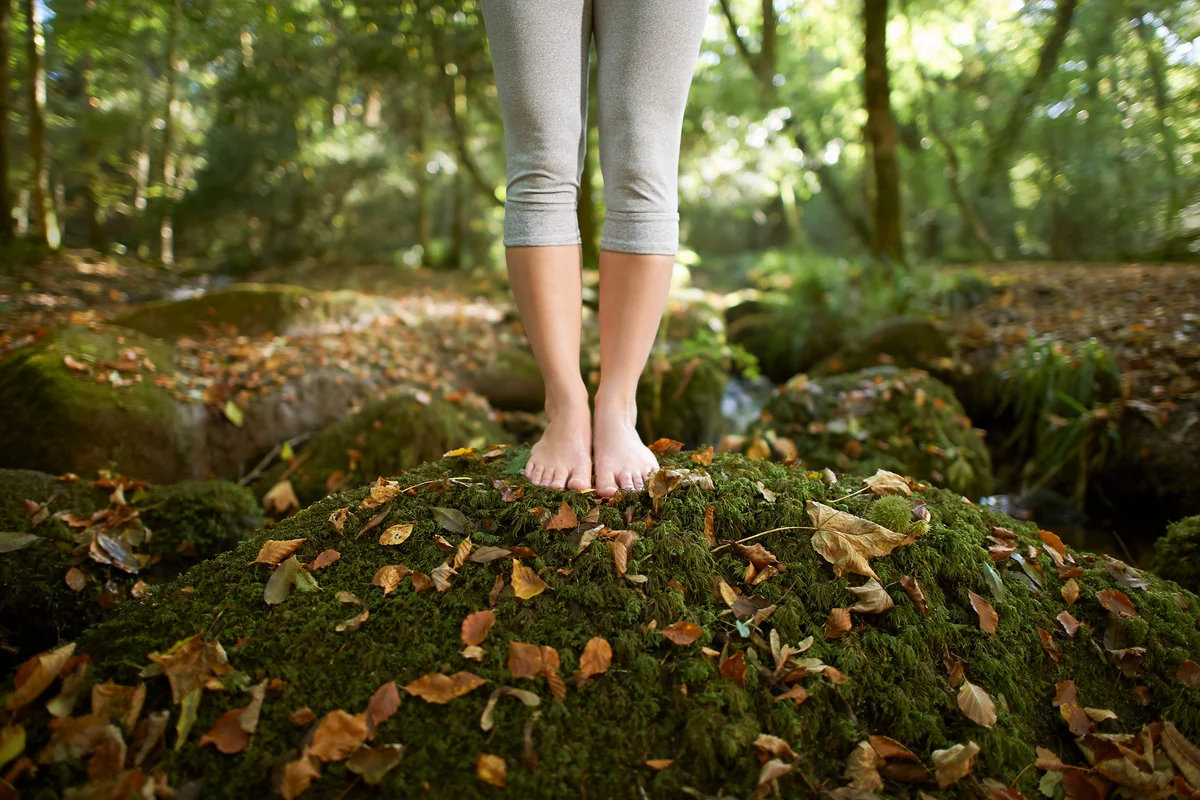 Woman walking barefoot in nature