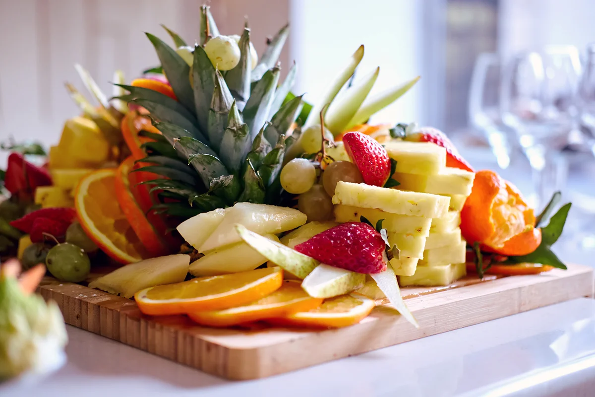 Slicing fruits on a wooden board close-up