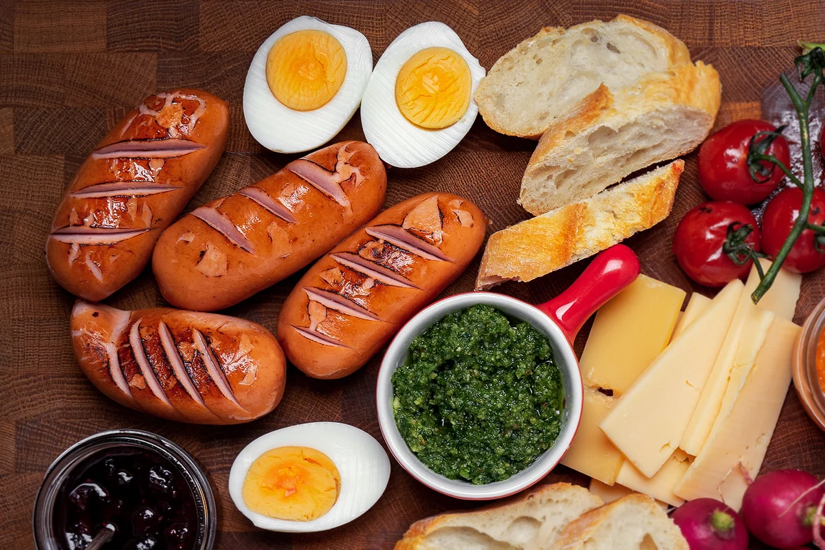 brunch board with sausages, eggs, breads and vegetables