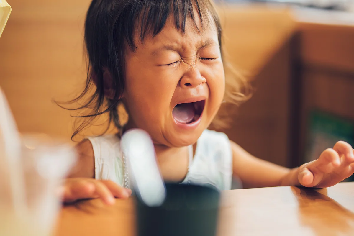Little girl crying at the restaurant