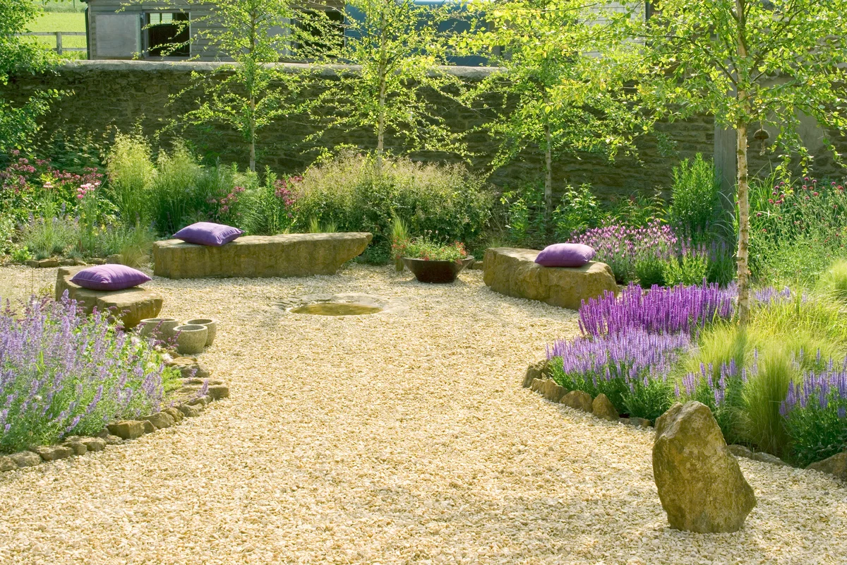 Gravel garden with rock seats and wild flowers