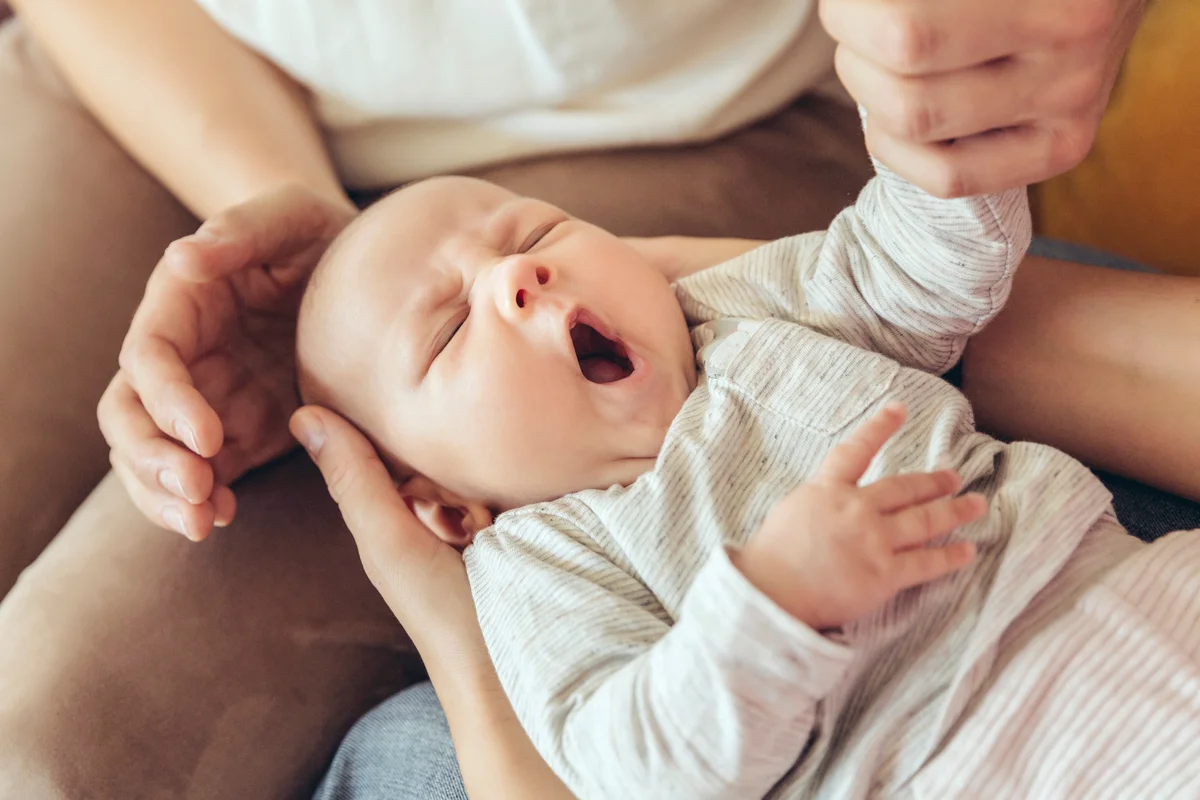 Sleepy baby being held