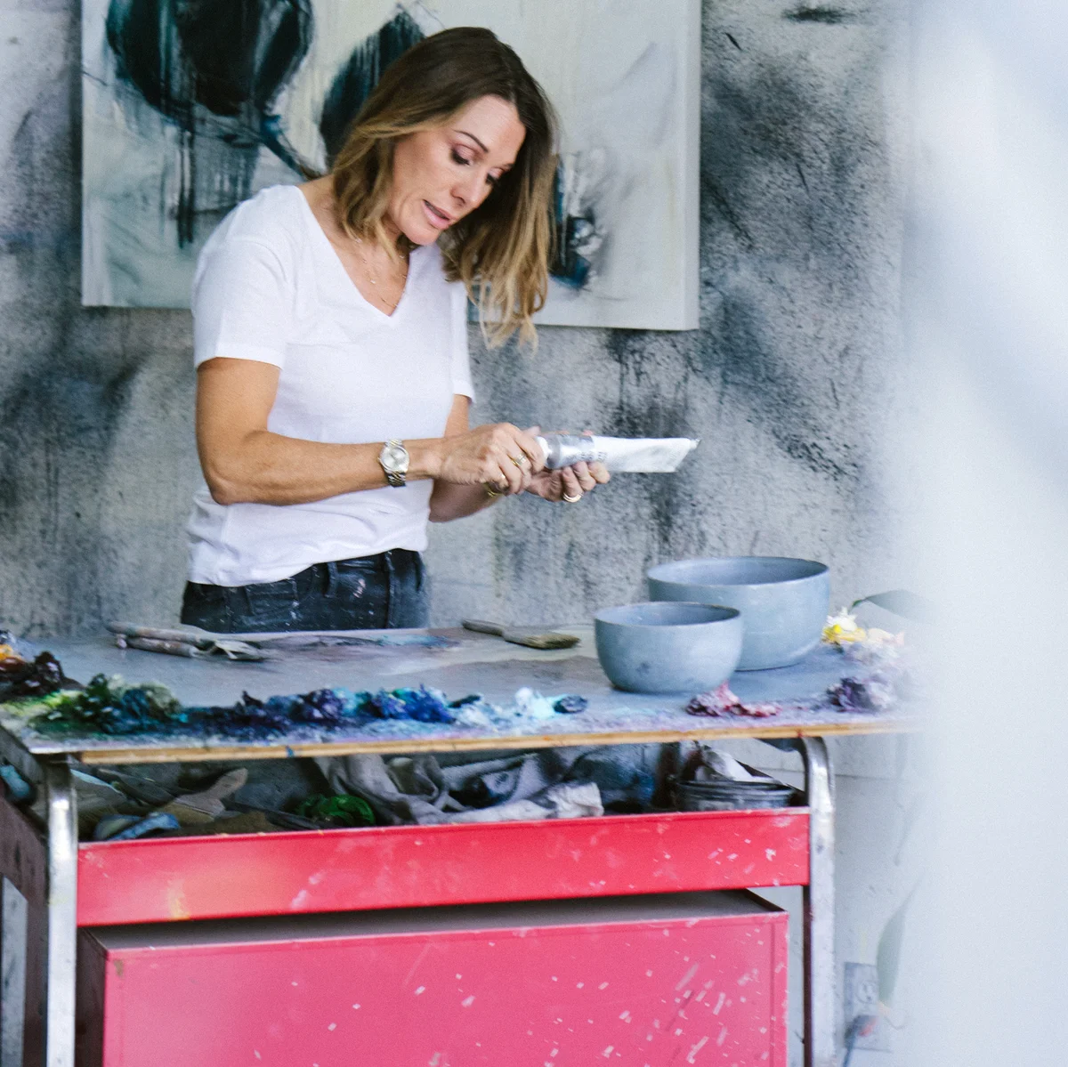 Woman painting canvas in art studio