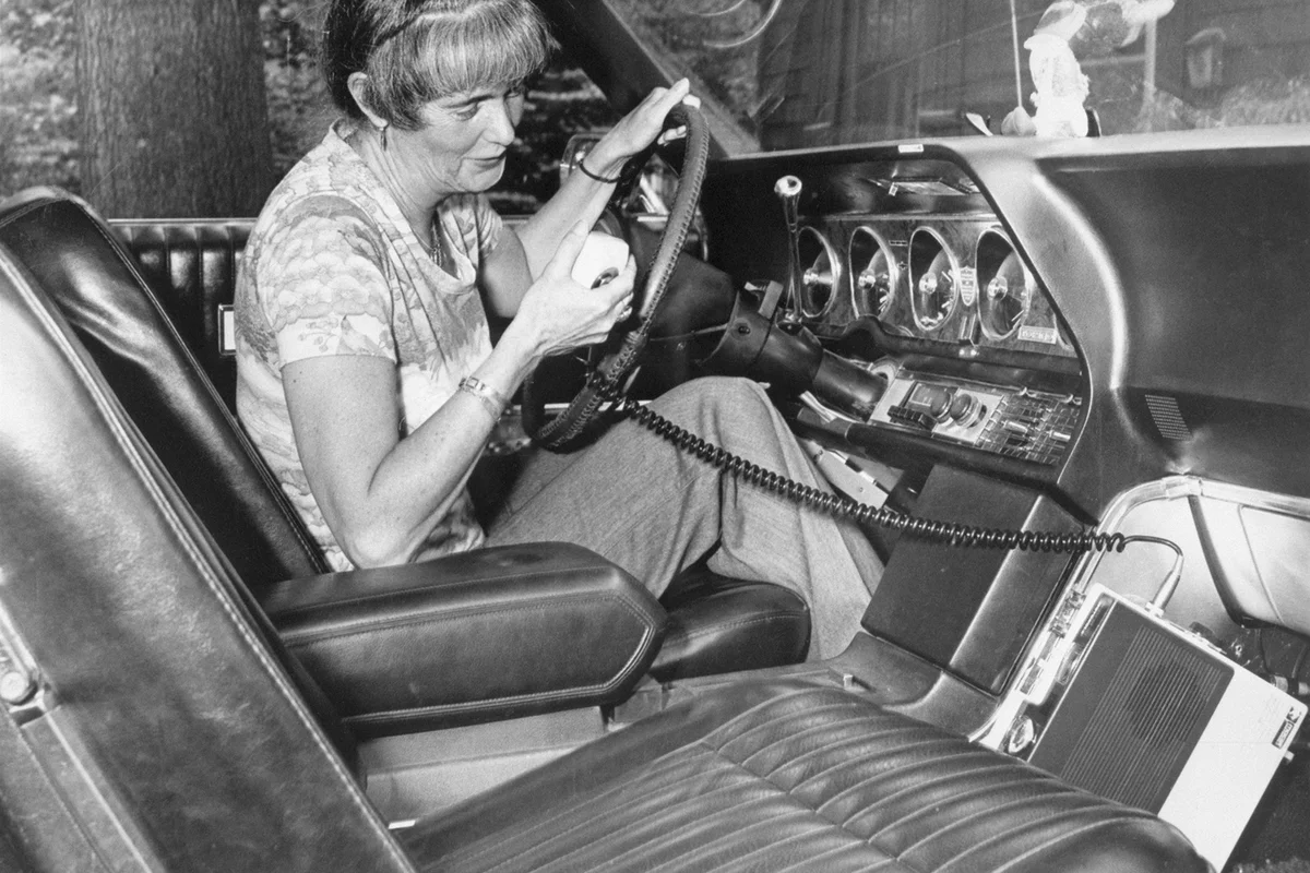 Sitting in her auto, Mrs. Louise Parsons of Natick, Mass., uses her CB radio
