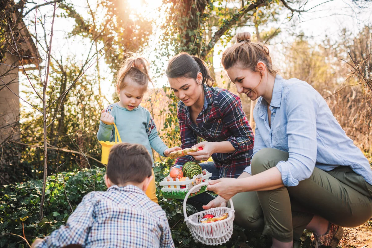 Cute little kids and their moms during Easter egg hunt