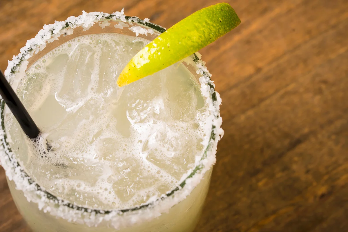 Margarita in a glass with a slice of lime and a salt-coated rim