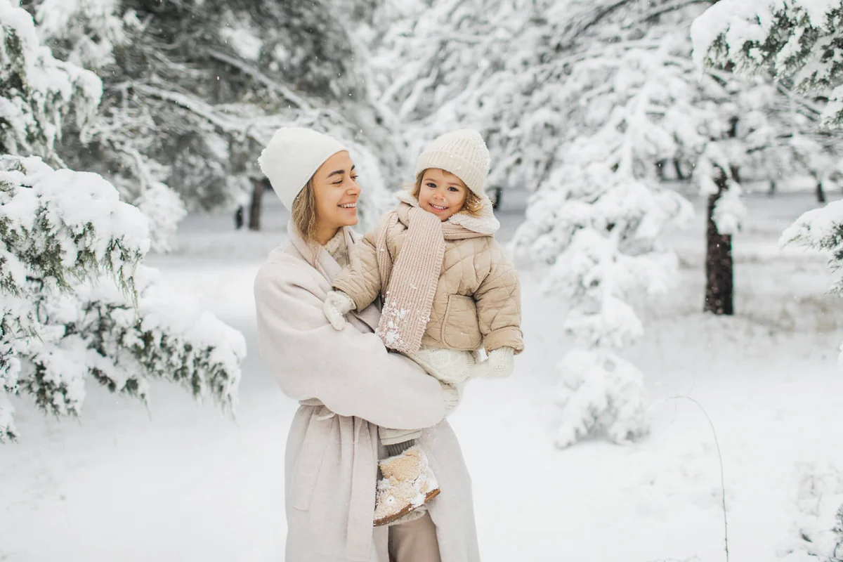 Happy mother and daughter enjoying winter