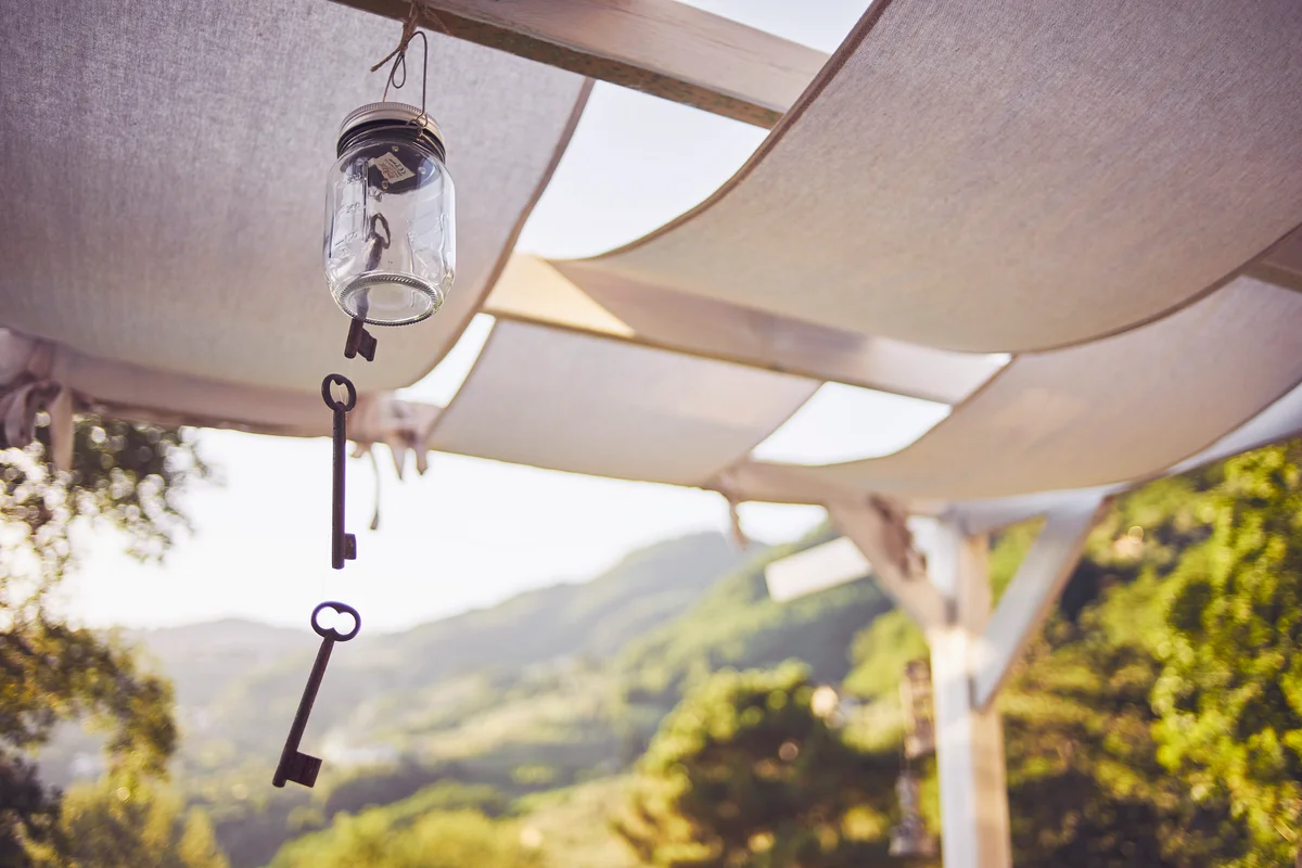 Key wind chime hanging from patio rafter
