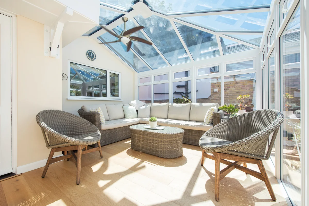 Interior patio with ceiling fan, rattan corner sofa and oval coffee table