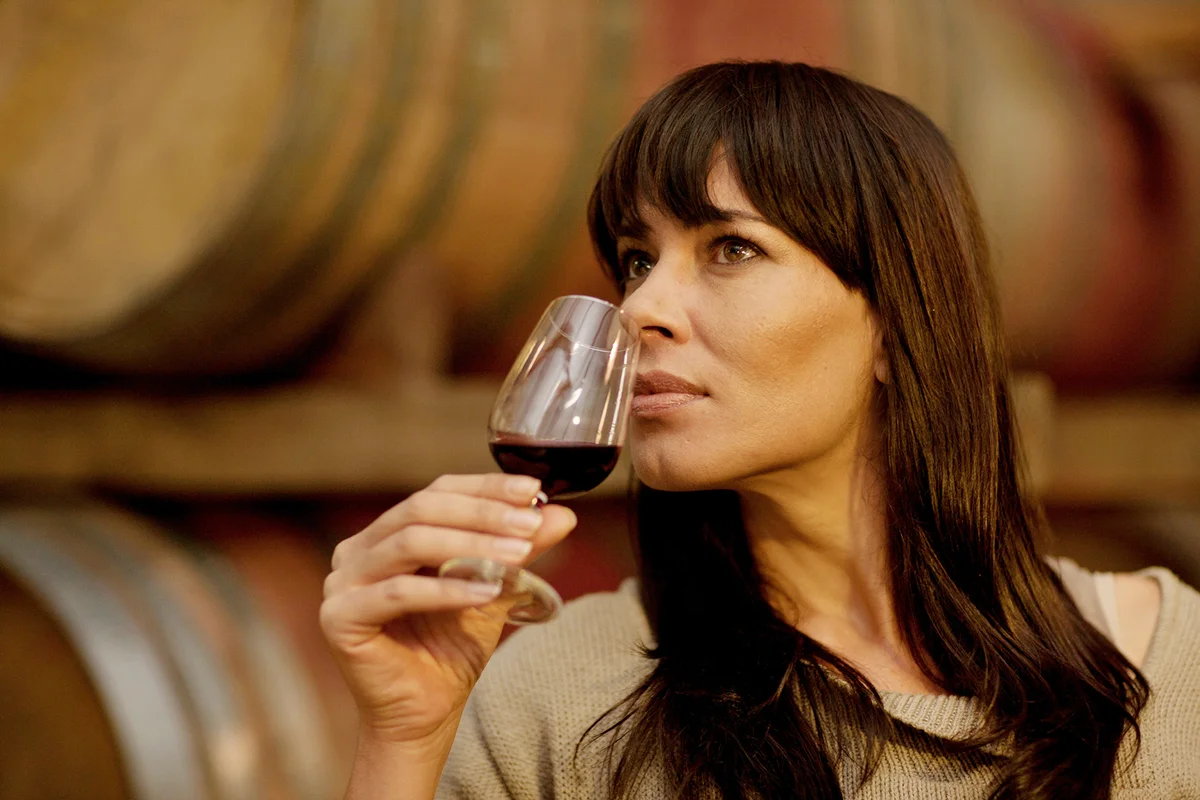 Woman smelling glass of wine