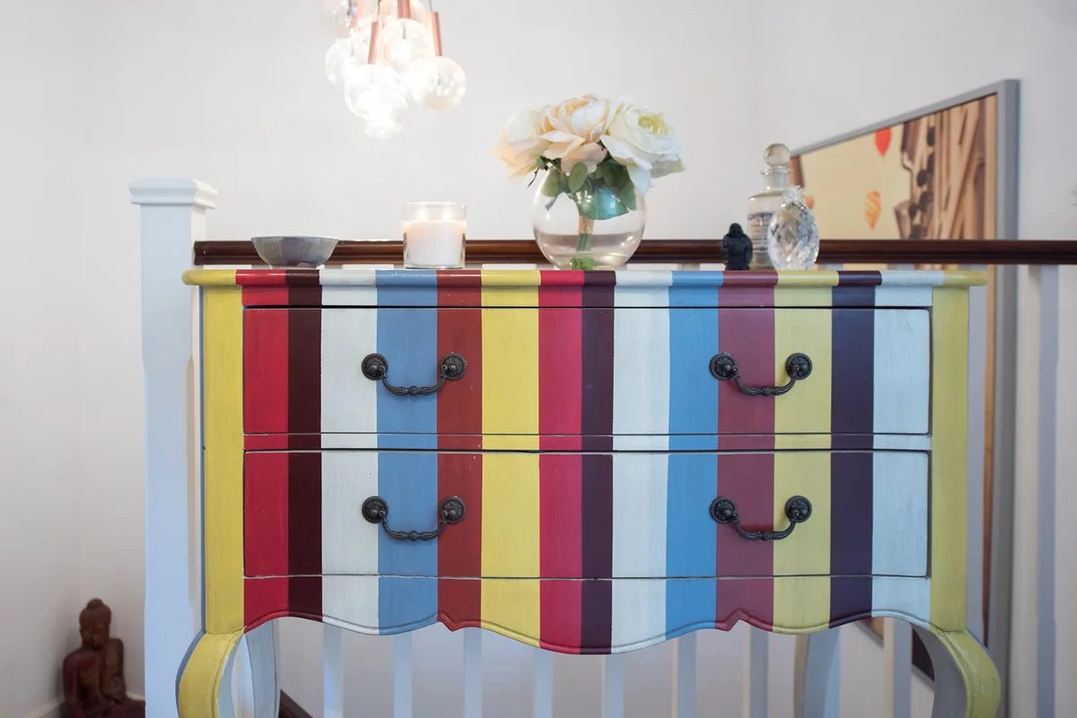 A general view of a stripey multi coloured chest of drawer