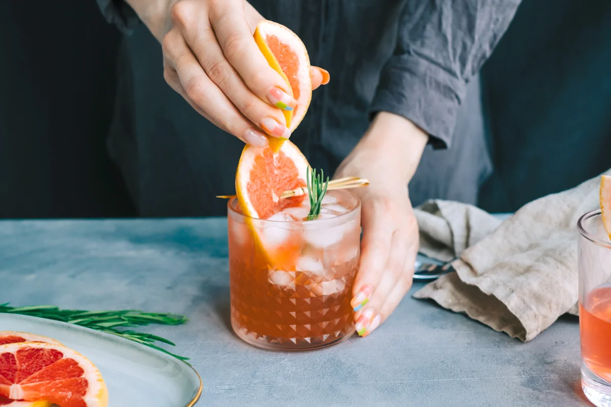 Woman making signature cocktail