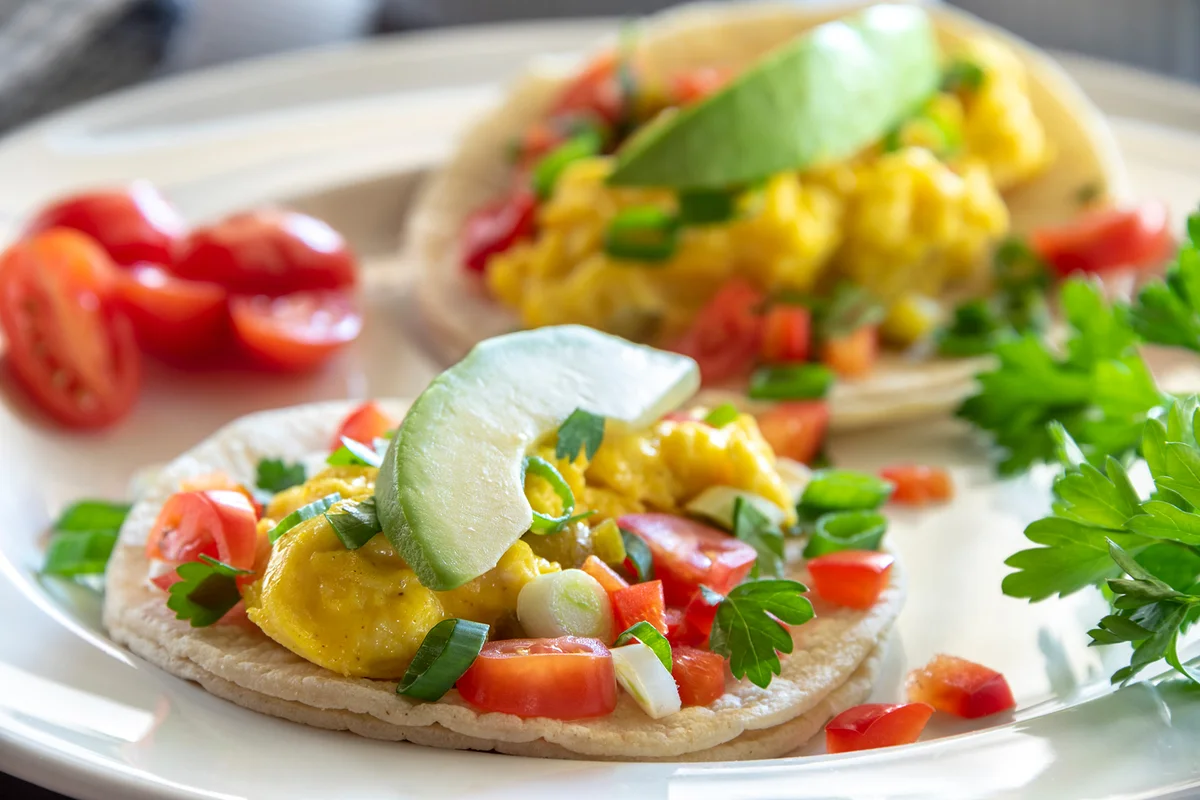 Two breakfast tacos on a white plate