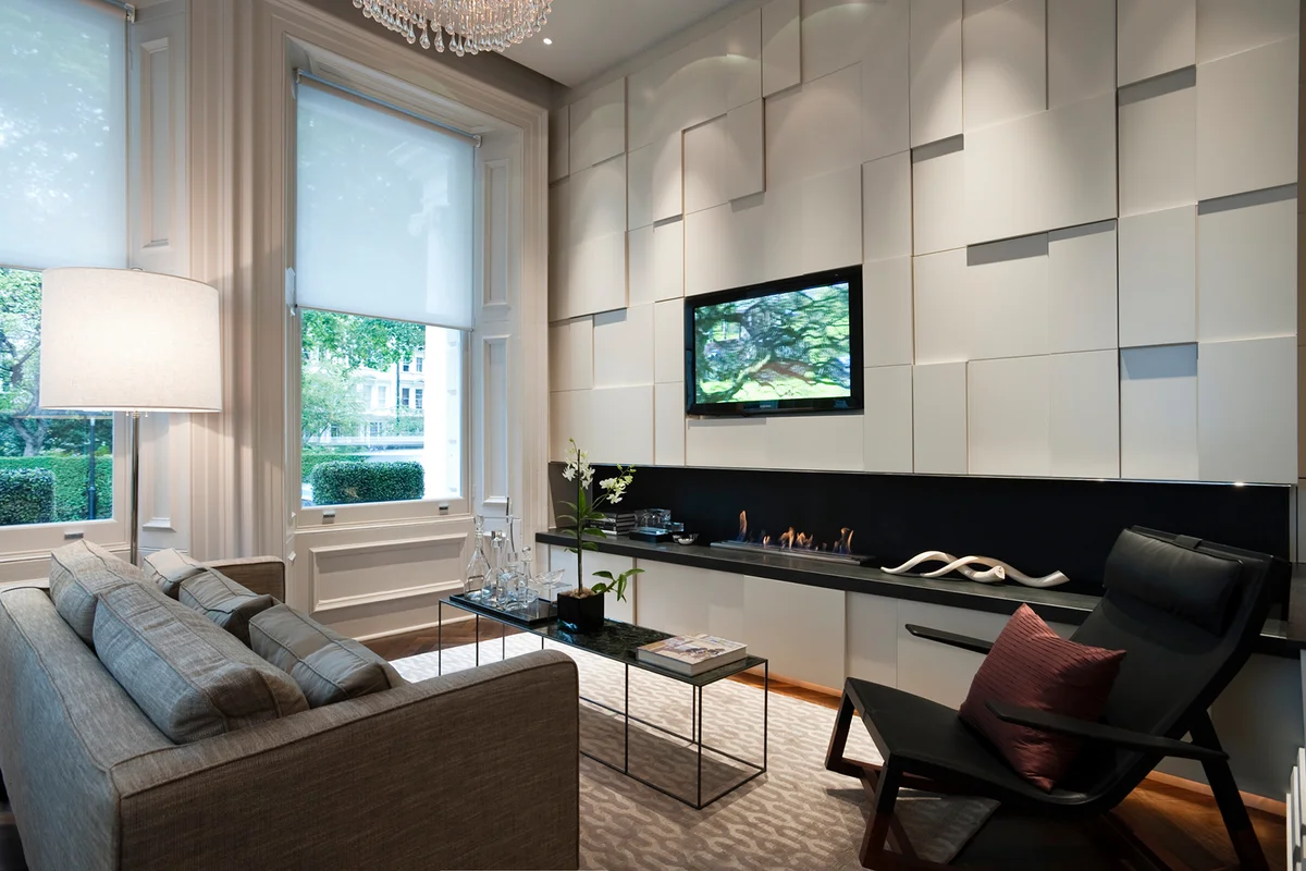 Seating area with plasma screen and recessed fire in London city apartment
