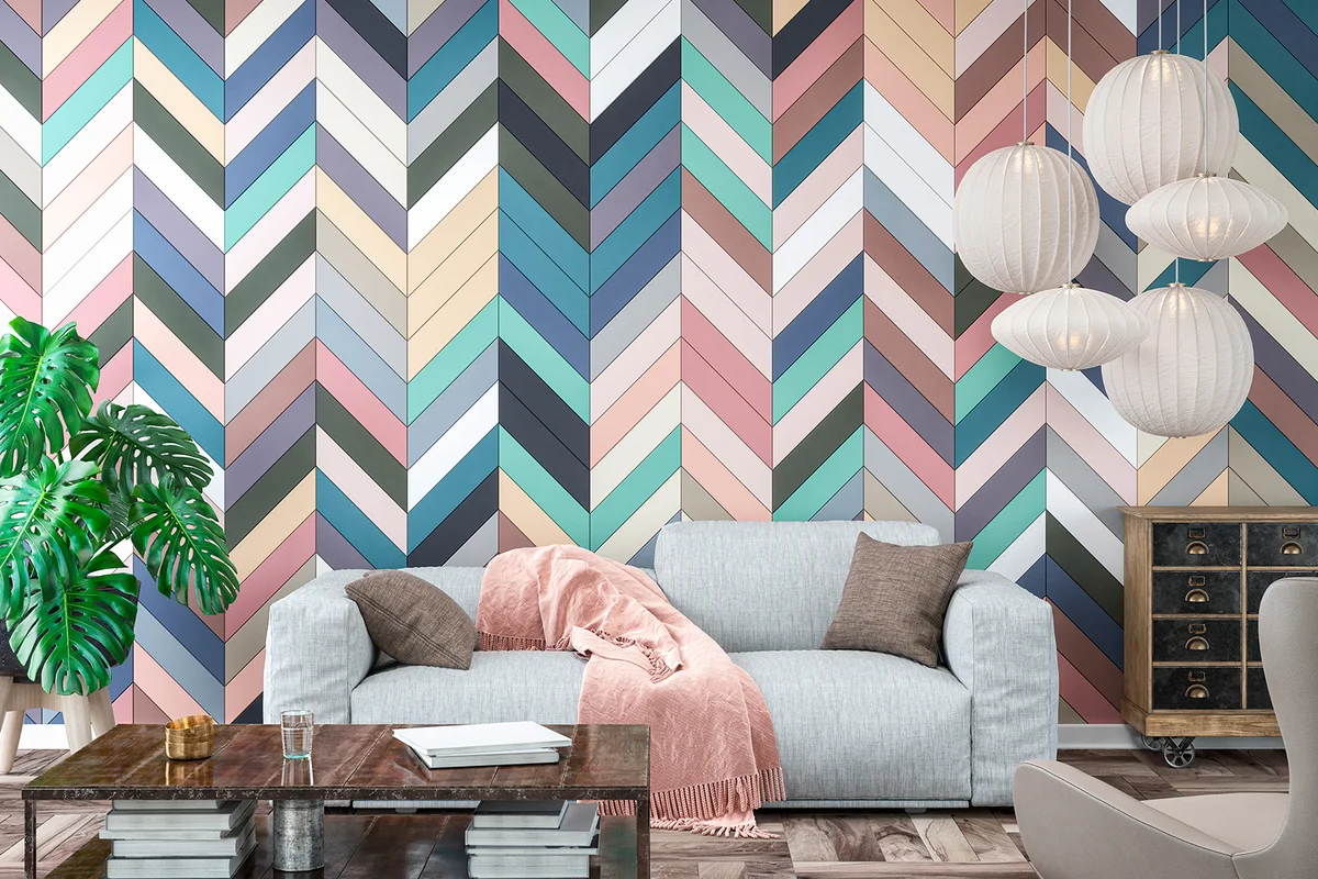 Modern living room with gray sofa, chair, table and decoration on hardwood floor in front of multicolored herringbone pattern tiled wall