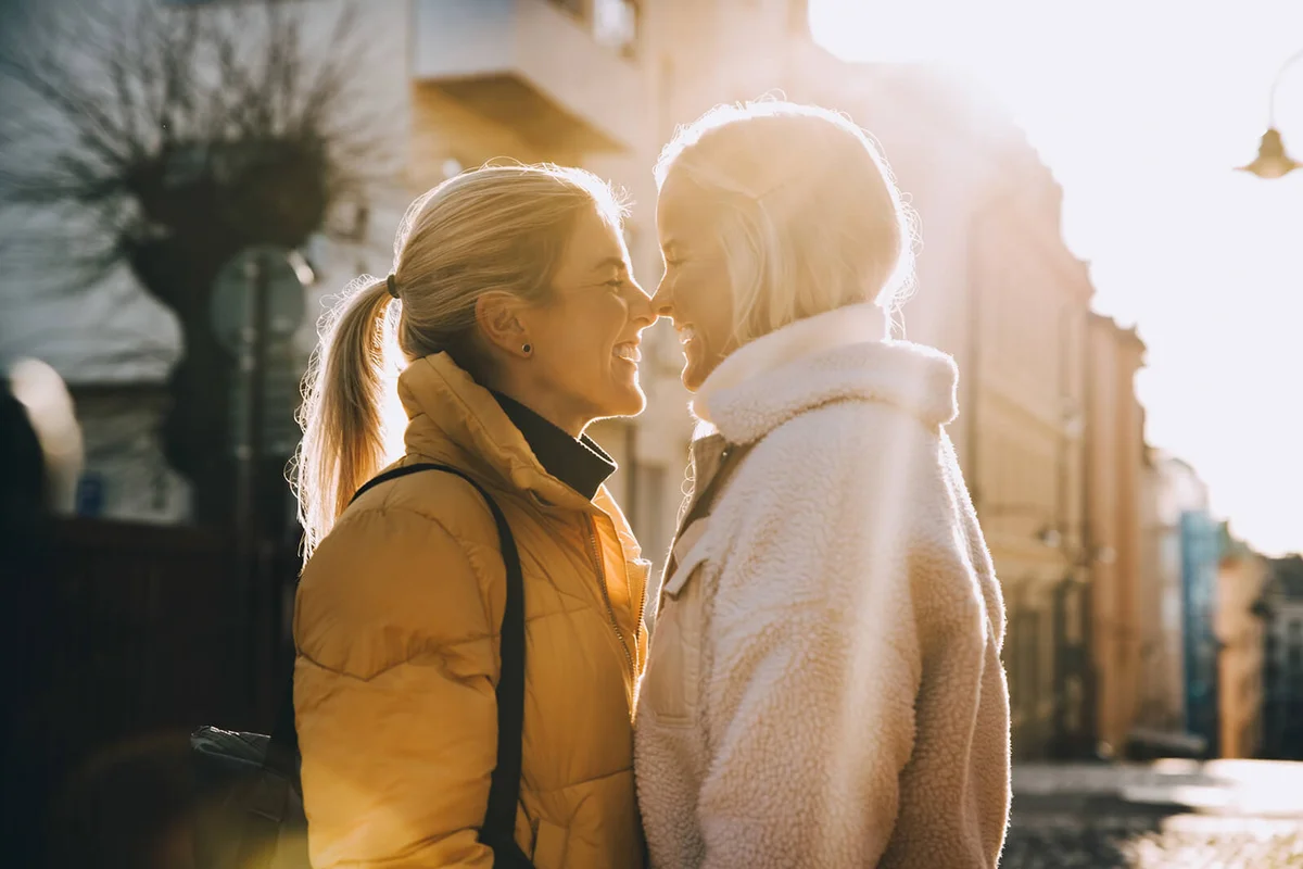 Happy woman embracing female partner