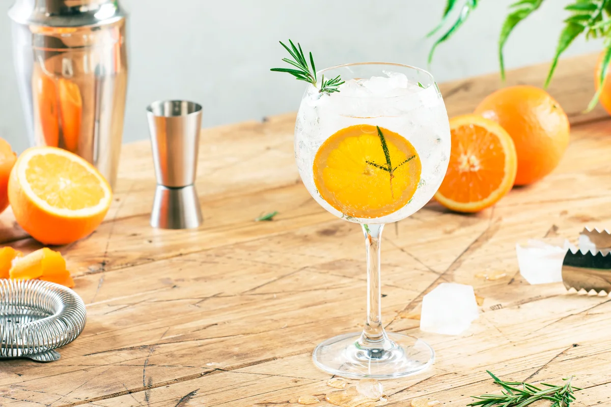Gin tonic cocktail with orange and rosemary