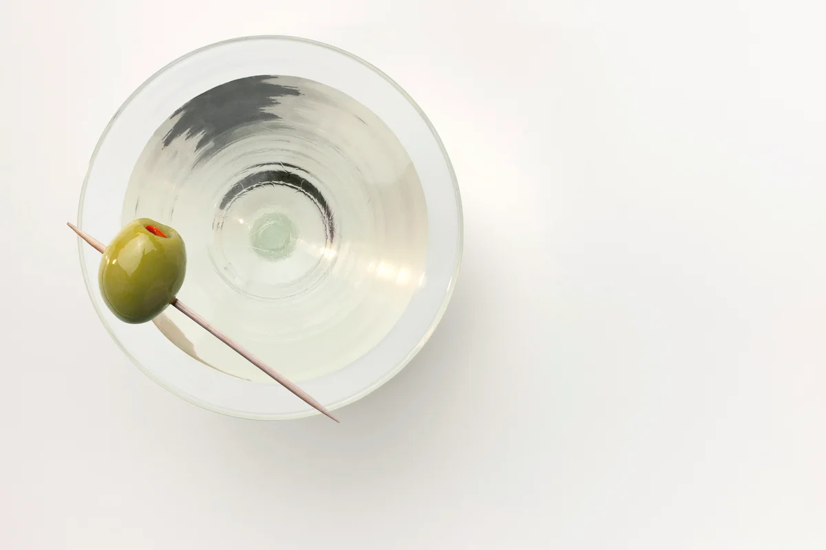 Martini served with a stuffed olive