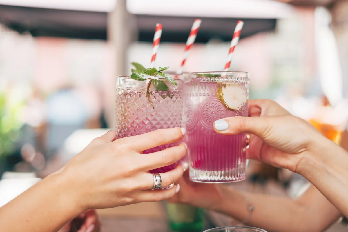 Three women making a celebratory toast