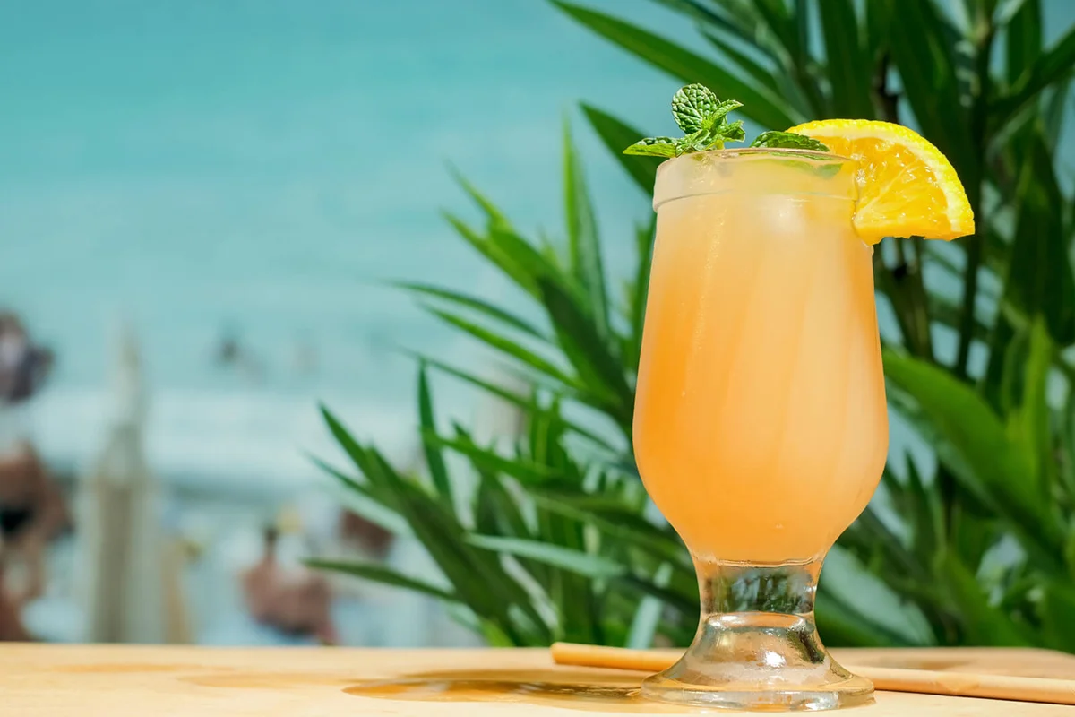 Orange punch cocktail at summer beach bar