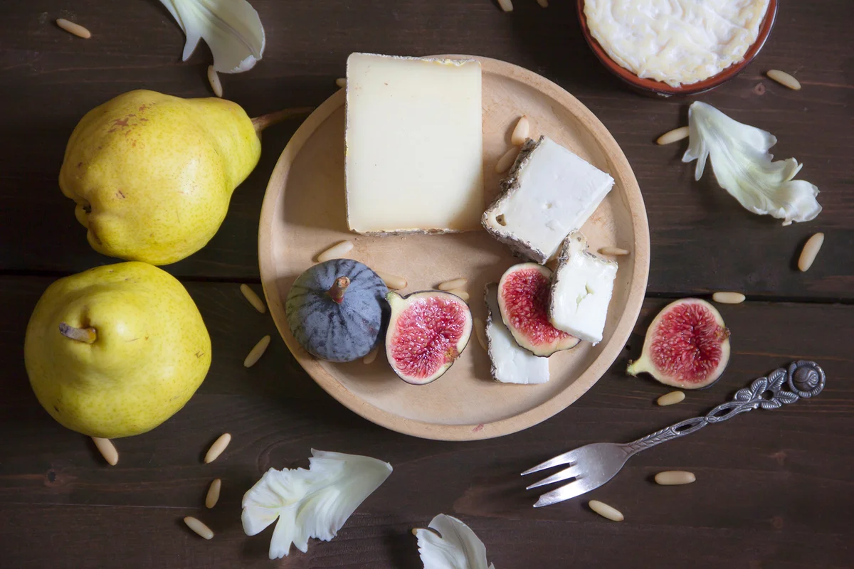 Variety of cheese, pears, figs and pine nuts