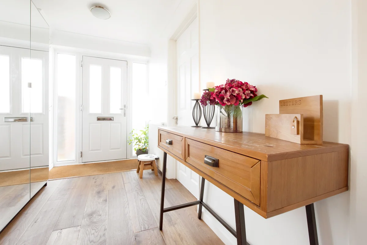 A wooden hall console table with metal legs