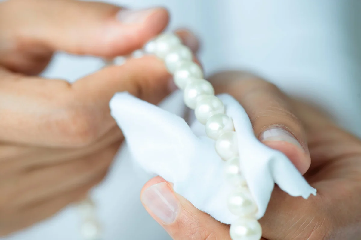 Woman Polishing Pearl Necklace