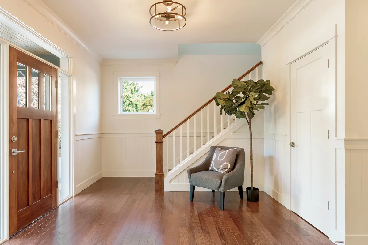 Armchair and tree in house entryway