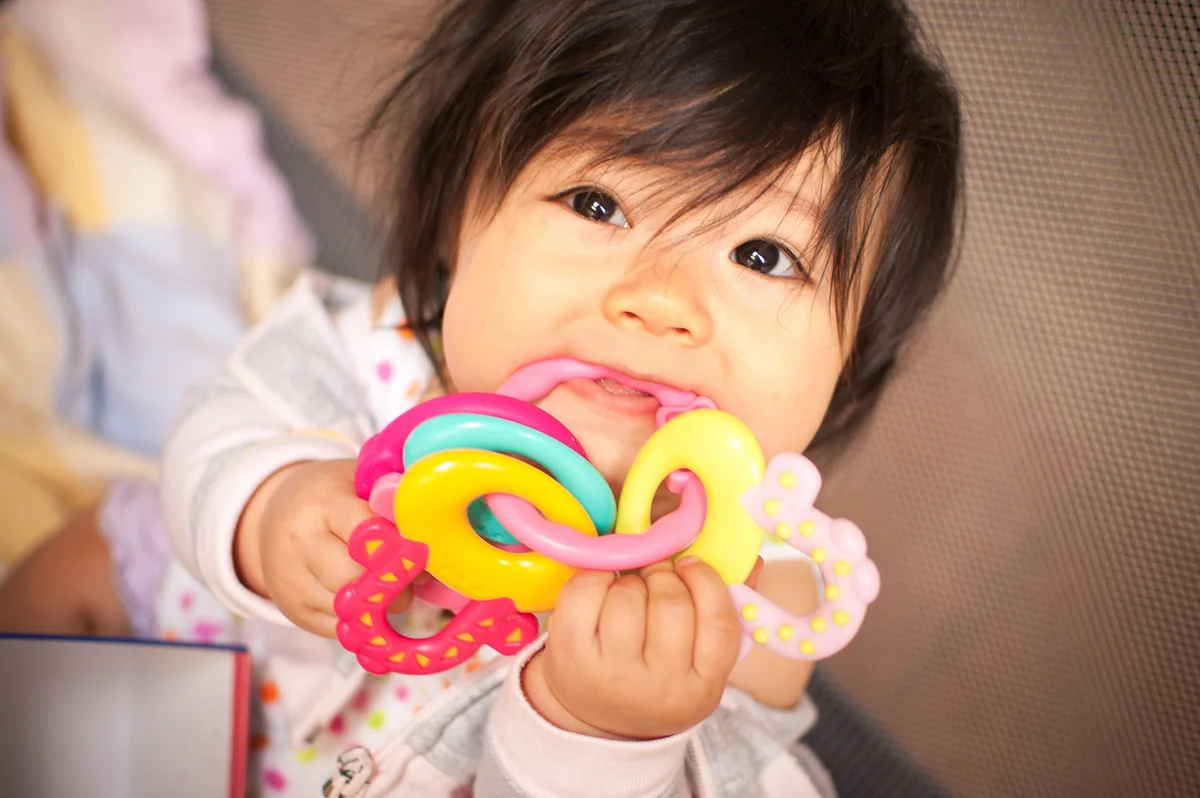 baby with teething toy
