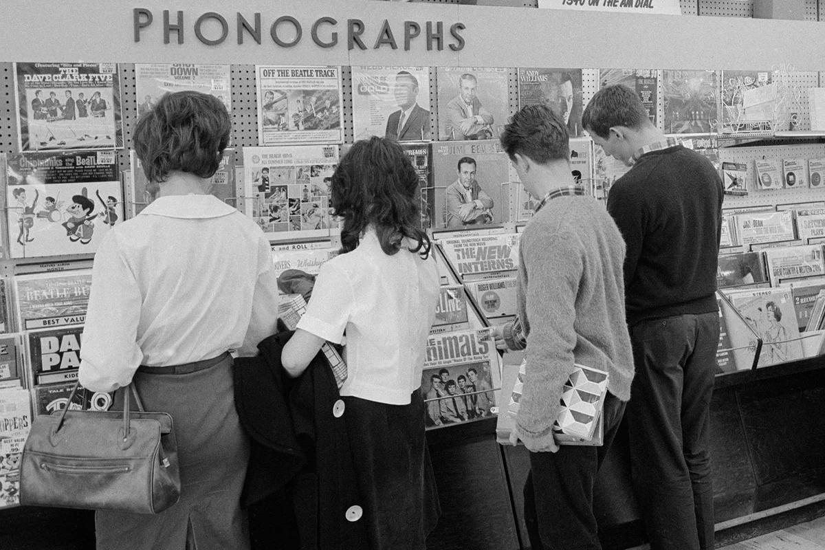 View, from behind, of customers as they browse racks of a vinyl albums at an unspecified record store - Getty Editorial