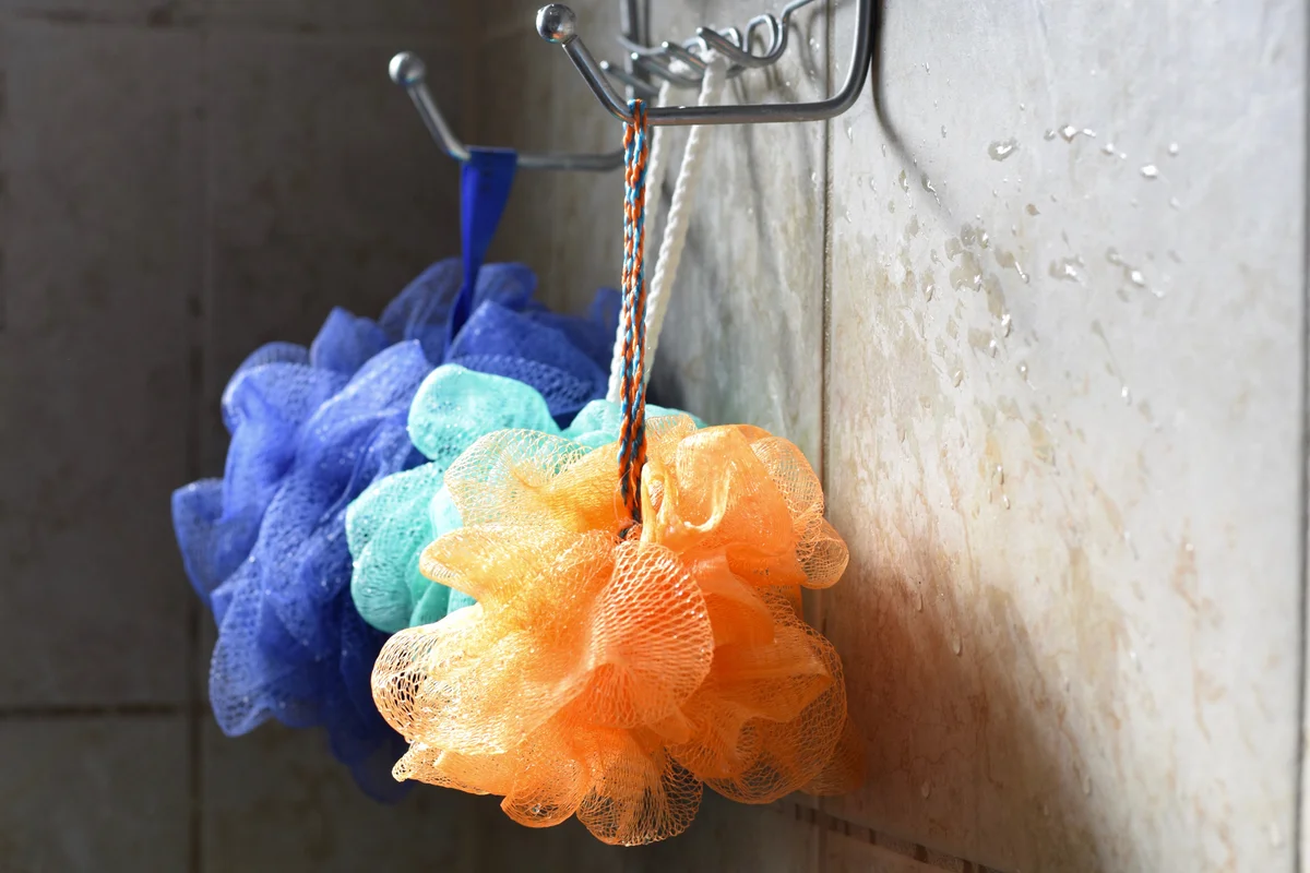 bath poufs hanging in a shower