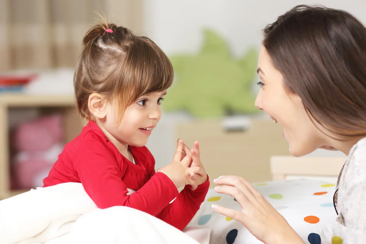 Babysitter and toddler playing together